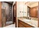 Bathroom features a decorative granite countertop and tiled shower stall at 10707 E Cottontail Ln, Scottsdale, AZ 85255