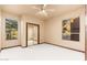 Bright bedroom with mirrored closet doors and views from multiple windows at 10707 E Cottontail Ln, Scottsdale, AZ 85255