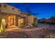 Exterior angle featuring a small waterfall and desert landscaping at dusk at 10707 E Cottontail Ln, Scottsdale, AZ 85255