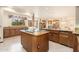 Kitchen with kitchen island with cooktop and granite countertops at 10707 E Cottontail Ln, Scottsdale, AZ 85255