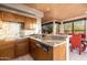 Kitchen featuring granite countertops, wood cabinetry and stainless dishwasher at 10707 E Cottontail Ln, Scottsdale, AZ 85255