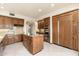 Kitchen features an island cooktop, tile floors, stainless steel appliances, and custom cabinets at 10707 E Cottontail Ln, Scottsdale, AZ 85255