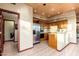 Traditional kitchen with stainless steel appliances and access to a powder room at 10707 E Cottontail Ln, Scottsdale, AZ 85255