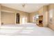 Open-plan living room with fireplace, ceiling fan and arched doorway at 10707 E Cottontail Ln, Scottsdale, AZ 85255