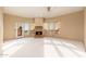 Spacious living room featuring fireplace, large windows and carpet at 10707 E Cottontail Ln, Scottsdale, AZ 85255