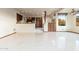 Bright living room features tile floors, wood beam, cabinetry, and views from large windows at 10707 E Cottontail Ln, Scottsdale, AZ 85255