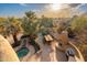 Aerial view of outdoor dining and kitchen area with a spa and desert landscape views at 10707 E Cottontail Ln, Scottsdale, AZ 85255