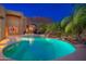 Large swimming pool with desert landscaping, a waterfall, and desert views at 10707 E Cottontail Ln, Scottsdale, AZ 85255