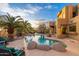 Beautiful pool area featuring desert landscaping, rock features and blue skies, creating a tranquil outdoor space at 10707 E Cottontail Ln, Scottsdale, AZ 85255