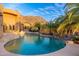 Stunning pool area with desert views, palm trees, and rock features, creating an oasis for relaxation and recreation at 10707 E Cottontail Ln, Scottsdale, AZ 85255