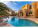 Inviting pool with rock features and desert surroundings, perfect for enjoying warm days and creating a relaxing ambiance at 10707 E Cottontail Ln, Scottsdale, AZ 85255