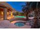 Swimming pool and hot tub with rock waterfall features in backyard with mountain views at 10707 E Cottontail Ln, Scottsdale, AZ 85255