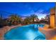 Backyard swimming pool with tropical landscaping, rock features, and lounge chairs at 10707 E Cottontail Ln, Scottsdale, AZ 85255