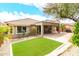 Exterior view of home featuring a covered patio, turf, desert landscaping and tile roof at 11352 E Starkey Ave, Mesa, AZ 85212