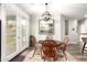 Inviting dining area with an elegant chandelier, hardwood floors, and backyard access at 11352 E Starkey Ave, Mesa, AZ 85212