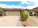 Charming single-story home featuring a tile roof, desert landscaping, and a spacious two-car garage at 11352 E Starkey Ave, Mesa, AZ 85212