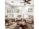 Comfortable living room featuring two armchairs, unique wood coffee table and ceiling fan at 11352 E Starkey Ave, Mesa, AZ 85212