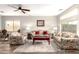 Charming living room with tile flooring, floral sofas, and recessed lighting at 11352 E Starkey Ave, Mesa, AZ 85212