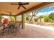 Relaxing covered patio with ceiling fans and an outdoor dining set, perfect for entertaining at 11352 E Starkey Ave, Mesa, AZ 85212