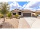 Charming single-story home with a well-manicured front yard and a brick paver walkway at 11831 W Daley Ct, Sun City, AZ 85373