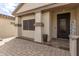 Charming entryway with a brick paver porch and decorative front door at 11831 W Daley Ct, Sun City, AZ 85373