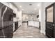 Stylish kitchen features black appliances, granite countertops, and a pantry, making meal preparation a breeze at 11831 W Daley Ct, Sun City, AZ 85373