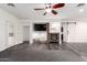 Bright living room featuring a stone fireplace, modern floors, and barn door at 11831 W Daley Ct, Sun City, AZ 85373