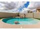 Backyard swimming pool featuring a rock waterfall feature and surrounding turf at 11831 W Daley Ct, Sun City, AZ 85373