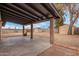 Spacious backyard featuring a covered patio, rock landscaping, and storage sheds at 1201 S 80Th St, Mesa, AZ 85209