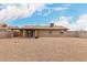 Backyard with rock landscaping featuring a covered patio and brick exterior at 1201 S 80Th St, Mesa, AZ 85209