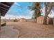 Large backyard featuring rock landscaping and multiple storage sheds at 1201 S 80Th St, Mesa, AZ 85209