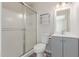 Bathroom featuring a glass enclosed shower and a single sink vanity with gray cabinets at 1201 S 80Th St, Mesa, AZ 85209