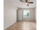 Bright bedroom with wood-look floors, a ceiling fan, and natural light from a window at 1201 S 80Th St, Mesa, AZ 85209