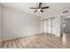 Neutral bedroom features wood-look flooring, ceiling fan, and closet with shelving at 1201 S 80Th St, Mesa, AZ 85209