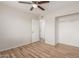 Bedroom features wood-look flooring, a ceiling fan, and a closet with shelving at 1201 S 80Th St, Mesa, AZ 85209