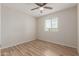 Bedroom with wood-look floors, ceiling fan, and natural light from the window at 1201 S 80Th St, Mesa, AZ 85209