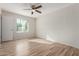 Sunlit bedroom featuring wood-look flooring, a ceiling fan, and a window with blinds at 1201 S 80Th St, Mesa, AZ 85209