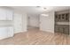 Open layout of dining area, with new wood floors flowing into adjacent rooms, including the white kitchen at 1201 S 80Th St, Mesa, AZ 85209