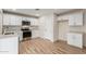 Well-lit kitchen features white cabinets, stainless steel appliances, and sleek countertops at 1201 S 80Th St, Mesa, AZ 85209