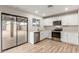 Bright kitchen featuring white cabinetry, stainless steel appliances, and wood-look flooring at 1201 S 80Th St, Mesa, AZ 85209