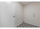 Functional laundry room with stylish black and white patterned tile flooring at 1201 S 80Th St, Mesa, AZ 85209