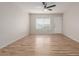 Open living room featuring new wood floors, a ceiling fan, and a large window with natural light at 1201 S 80Th St, Mesa, AZ 85209