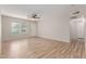 Bright living room showcasing new wood floors, a ceiling fan, and a white front door at 1201 S 80Th St, Mesa, AZ 85209