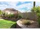 The sprawling backyard features vibrant landscaping and a stone wall, adding to the property's appeal at 13487 E Gold Dust Ave, Scottsdale, AZ 85259