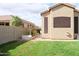 A manicured lawn complements the home's exterior, complete with garden boxes at 13487 E Gold Dust Ave, Scottsdale, AZ 85259