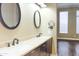 Bathroom featuring double sink vanity and wood floors at 13487 E Gold Dust Ave, Scottsdale, AZ 85259