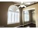 Bedroom showcasing a large window with shutters and a sliding mirror closet at 13487 E Gold Dust Ave, Scottsdale, AZ 85259