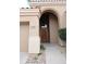 Inviting arched entryway with a wood front door and desert landscaping accents at 13487 E Gold Dust Ave, Scottsdale, AZ 85259