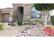 Close up of the desert landscaping featuring rocks, flowering bushes, and a small tree at 13487 E Gold Dust Ave, Scottsdale, AZ 85259