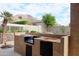 This view highlights the built-in grill area in the outdoor kitchen, ideal for entertaining at 13487 E Gold Dust Ave, Scottsdale, AZ 85259